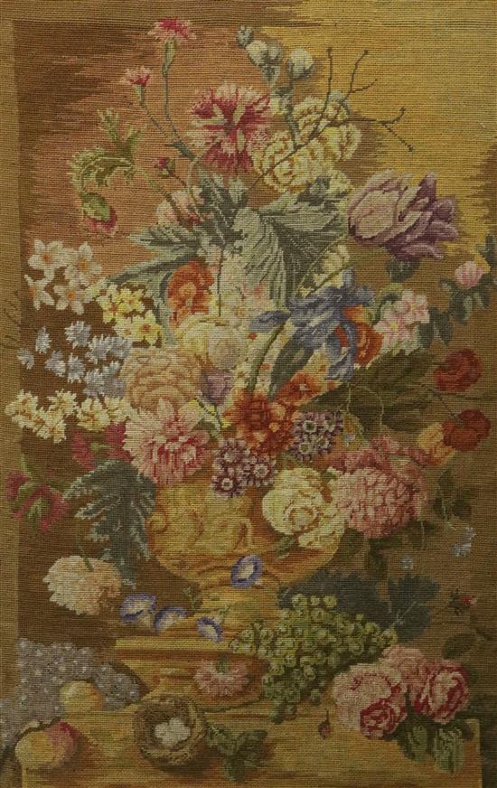 A needlework panel depicting flowers in an urn upon a ledge, worked by Alan Ely, 1939-40 at Bridport, overall 36 x 26in.